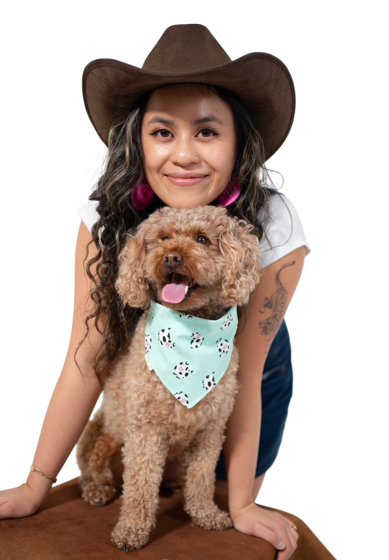 Kim in a cowboy hat with her curly-haired dog